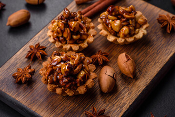 Sweet tasty tart with nuts and honey on a dark concrete background