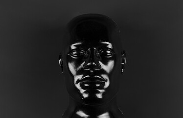 black mannequin head isolated on black background