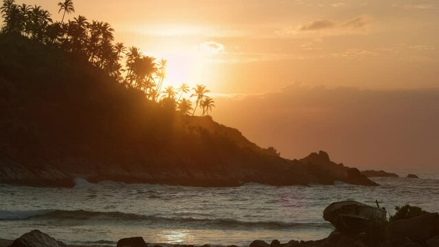 Dawn over the jungle. The sun rises over the ocean. Mirissa Secret Beach in Sri Lanka. Travel and natural concept.