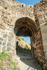 The arch of the stone gates of the entrance to the territory of the ancient castle made of ancient bricks.