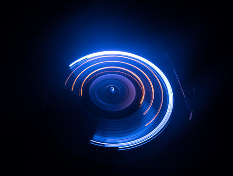 Music Dj concept. Trail of fire and smoke on vinyl record. Burning vinyl disk. Turntable vinyl record play Selective focus
