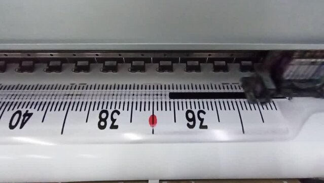 modern printer printing on wide format. Oracal photo printing. Head of printer during foto printing process. printer prints photo of thermometer for advertising sticker
