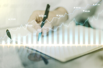 Multi exposure of abstract creative financial chart with hand writing in diary on background, research and analytics concept