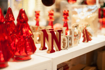 Christmas decoration with word Noel  on the table at decor shop in classic red color palette