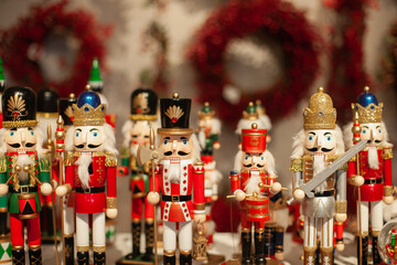 Nutcracker wooden toys army at Christmas market closeup. Winter holiday festive home decor. Handmade souvenir gift shop or store. 
