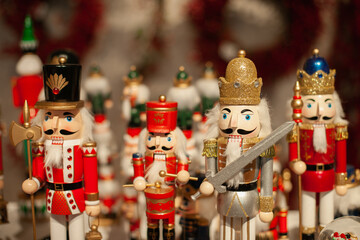 Nutcracker wooden toys army at Christmas market closeup. Winter holiday festive home decor. Handmade souvenir gift shop or store. 