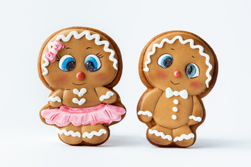 Christmas gingerbread men with white icing isolated on white background. Homemade festive traditional gingerbread cookies. Gingerbread couple. Merry Christmas