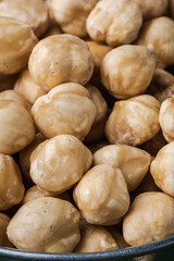 A pile of peeled hazelnuts as a textured background. Healthy nutrition concept