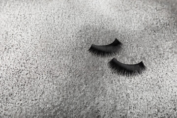 False eyelashes on a black marble background. Flatley. Beauty and fashion concept. Eyelash extension. beauty industry. Place for text. Place to copy.