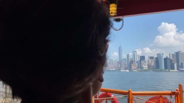 Young woman taking picture with smartphone staten island ferry magnificent views of skyscrapers in manhattan new york buildings seen from the river concept lifestyle city vacation adventure