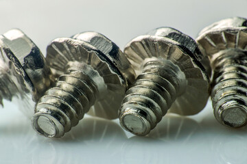 Small screws and bolts in stainless steel. macro photography slow motion closeup