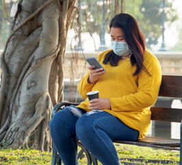 Portrait fat Asian woman long black hair wearing yellow shirt Are using mobile phone or smartphone...