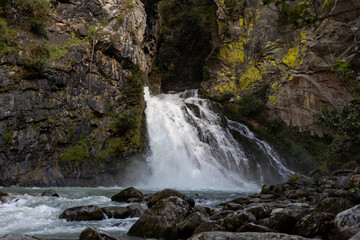 waterfall between old rocks beautiful nature background