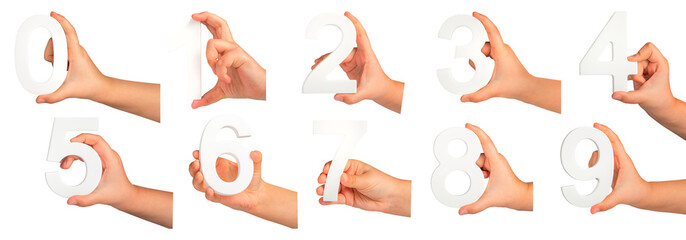 Children's hands hold numbers. A set of white numbers in hands on a black isolated background....
