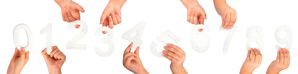 Children's hands hold numbers. A set of white numbers in hands on a black isolated background. Zero, one, two, three, four, five, six, seven, eight, nine