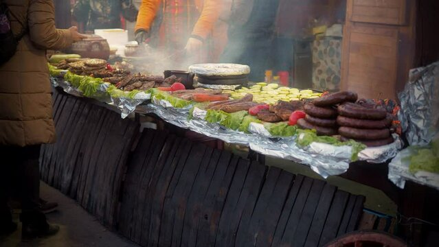 Balkan grill food fest. Grilled pork and chicken meat, lamb roasted on a spit - Christamas outdoor street food festival 