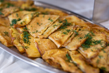 delicious triangular pancakes with greens laid out on a plate.