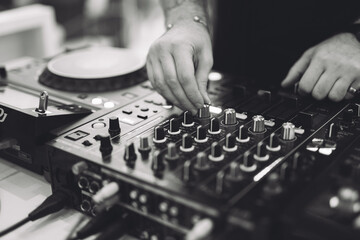Fototapeta premium a DJ plays music on a controller at a party.