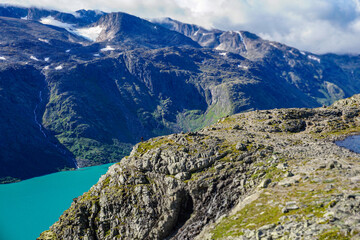 Fototapeta na wymiar A man near a precipice of a fjord horizontal photo