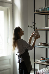 girl potter, business owner in her studio. the concept of small business, work with your own hands. space for text