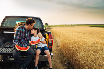 Father kisses his son on the forehead