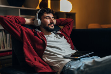 Man rests at home while listening to music