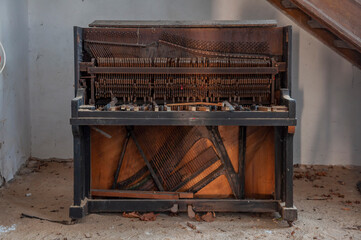 Destroyed piano in an abandoned old historic mansion palace in Poland in Central Europe