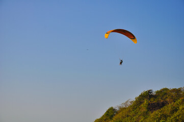 Paragliding flight in the sky of Arambol, Goa, India