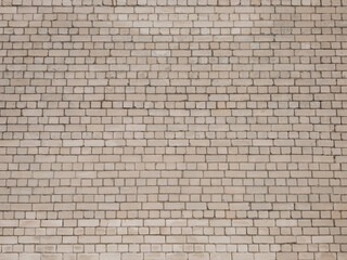 View of empty, white brick wall background with copy space. A deteriorating brick wall outdoors in sunlight