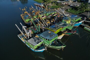 Drone View of colorful wooden fishing boats, moored at the south side of the Sarawak River, Kuching. - obrazy, fototapety, plakaty