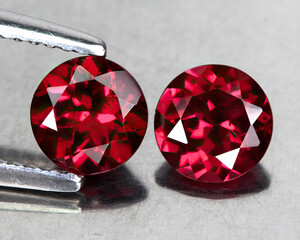 Natural gemstone rhodolite garnet isolated on the white background
