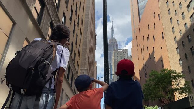 Young mother with two children visiting new york manhattan landmarks buildings skyline tourism summer family time lifestyle adventure