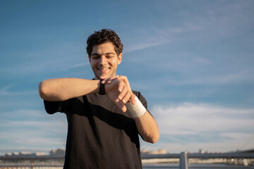 Fototapeta premium Fitness Watch on Hand Trainer exercise for fitness. A man is a strong active sport every day.