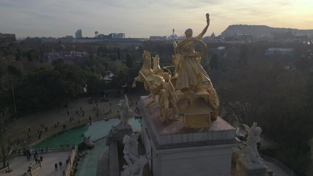flying clockwise around Quadriga de l'Aurora sculpture in Ciutadella Park Barcelona