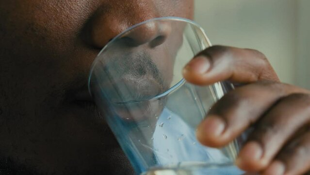 Healthy male businessman unknown african american man adult young guy employee drinking cold mineral fresh water keep aqua balance quench thirst good daily habit body hydration health care weight loss