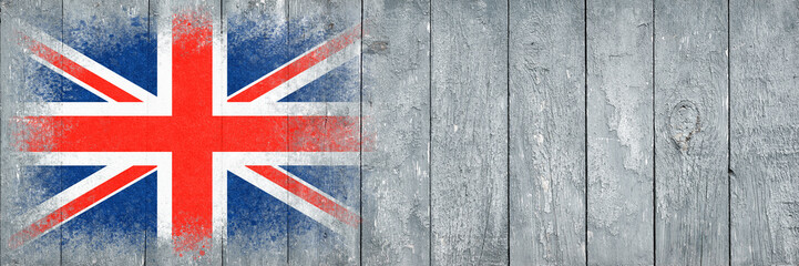 Flag of Britain. Flag is painted on a gray wooden plank surface. Wooden background. Plywood surface. Copy space. Textured background