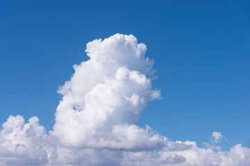 Cumulus white clouds in clear blue sky background
