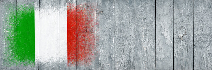 Flag of Italy. Flag is painted on a gray wooden plank surface. Wooden background. Plywood surface. Copy space. Textured background