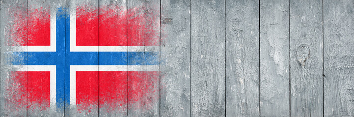 Flag of Norway. Flag is painted on a gray wooden plank surface. Wooden background. Plywood surface. Copy space. Textured background