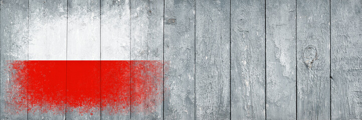 Flag of Poland. Flag is painted on a gray wooden plank surface. Wooden background. Plywood surface. Copy space. Textured background