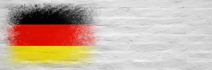 Flag of Germany. Flag painted on a white plastered brick wall. Brick background. Copy space. Textured background