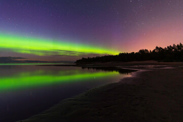 Northern lights, reflections in the water. Storsand Jakobstad/Pietarsaari. Finland