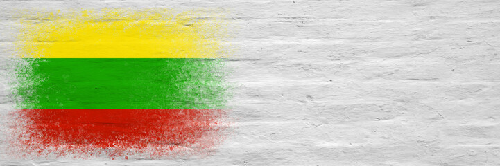 Obraz premium Flag of Lithuania. Flag painted on a white plastered brick wall. Brick background. Copy space. Textured background