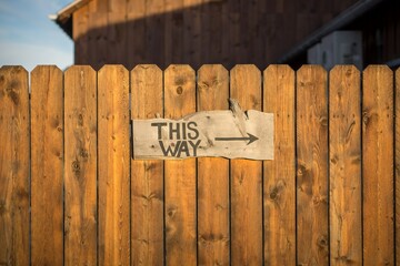 wooden sign on fence
