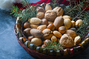 Nuts mix in a seasons basket and pine leaves for garnish