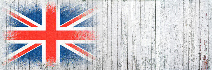 Flag of Britain. Flag is painted on a white wooden surface. Wooden background. Plywood surface. Copy space. Textured background