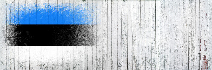Fototapeta premium Flag of Estonia. Flag is painted on a white wooden surface. Wooden background. Plywood surface. Copy space. Textured background
