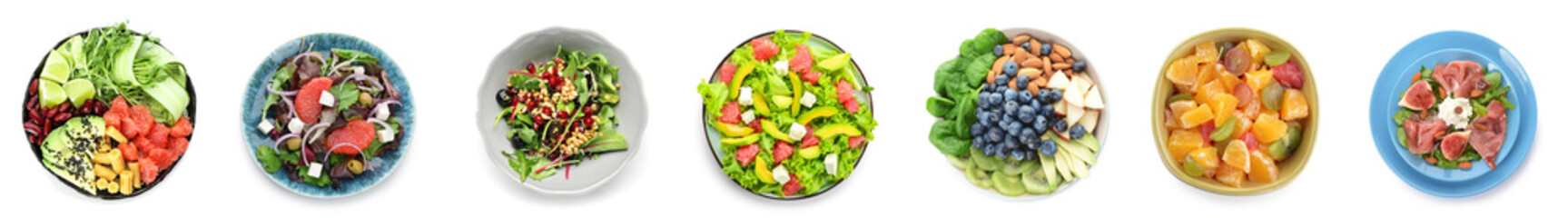 Group of plates with healthy salads on white background