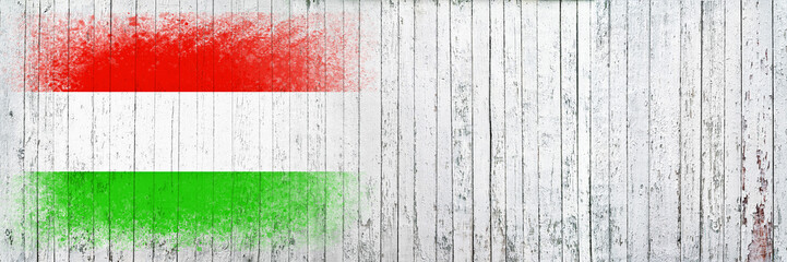 Flag of Hungary. Flag is painted on a white wooden surface. Wooden background. Plywood surface. Copy space. Textured background