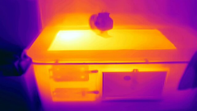 A thermal camera on the stove in the kitchen with the red colors in Estonia